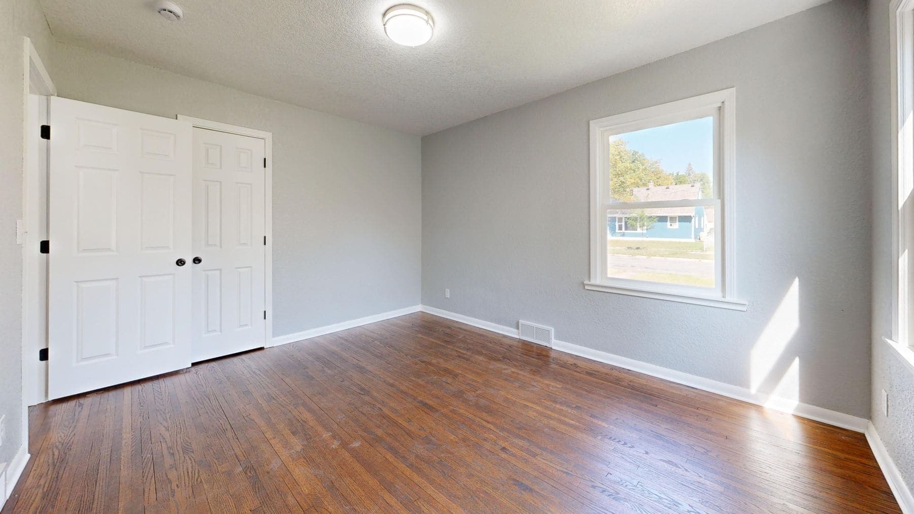 The same room after a bright, even repaint with crisp white trim