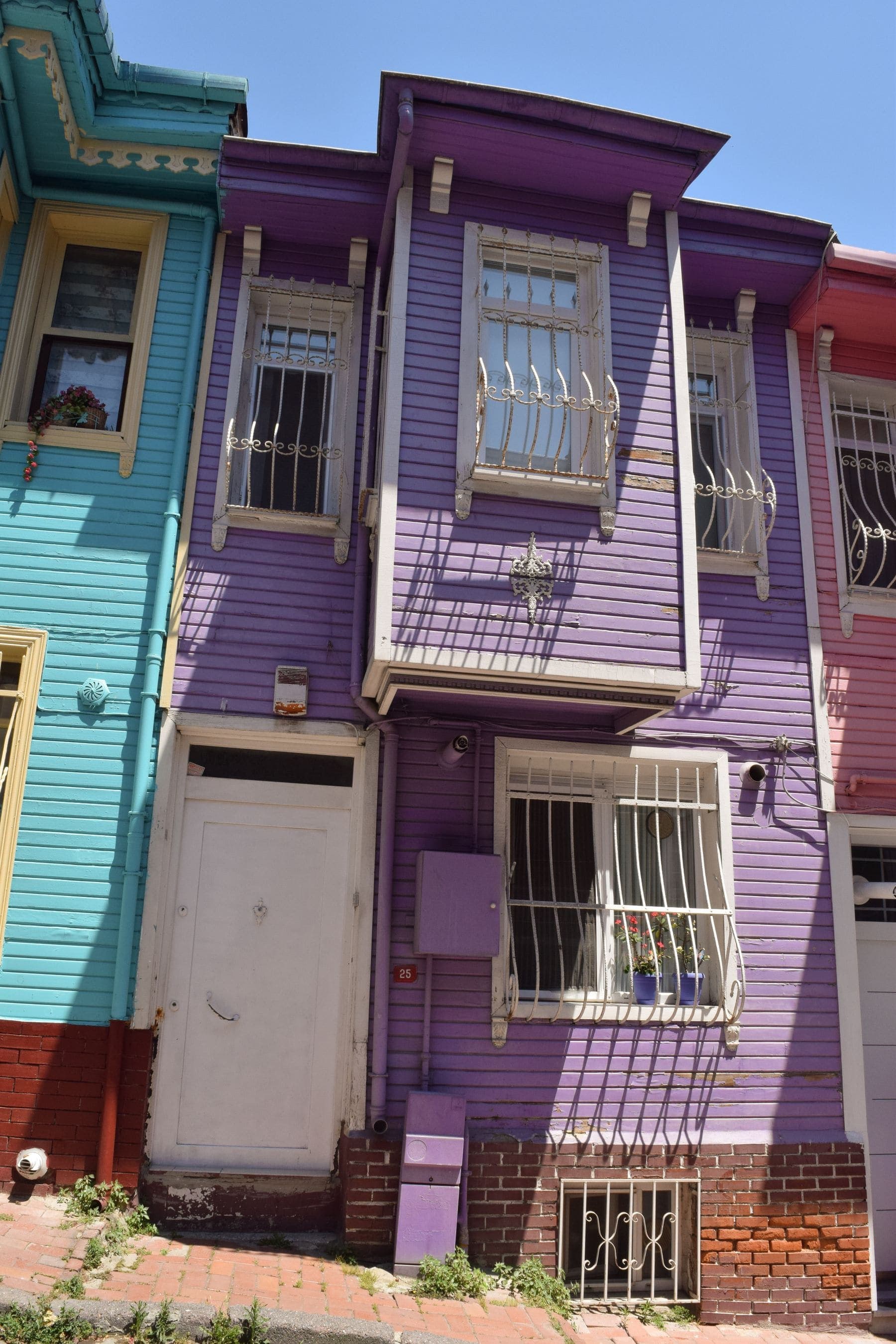 Row of houses painted in a range of exterior colour palettes