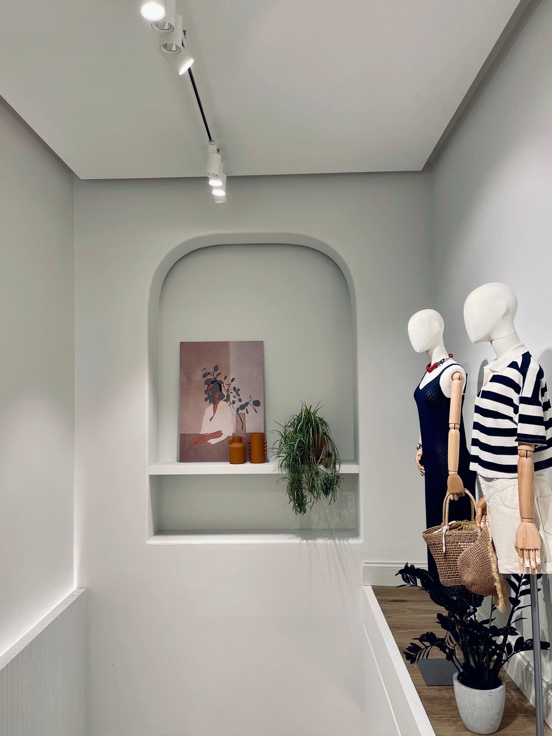 Minimal boutique retail interior with a smooth painted finish