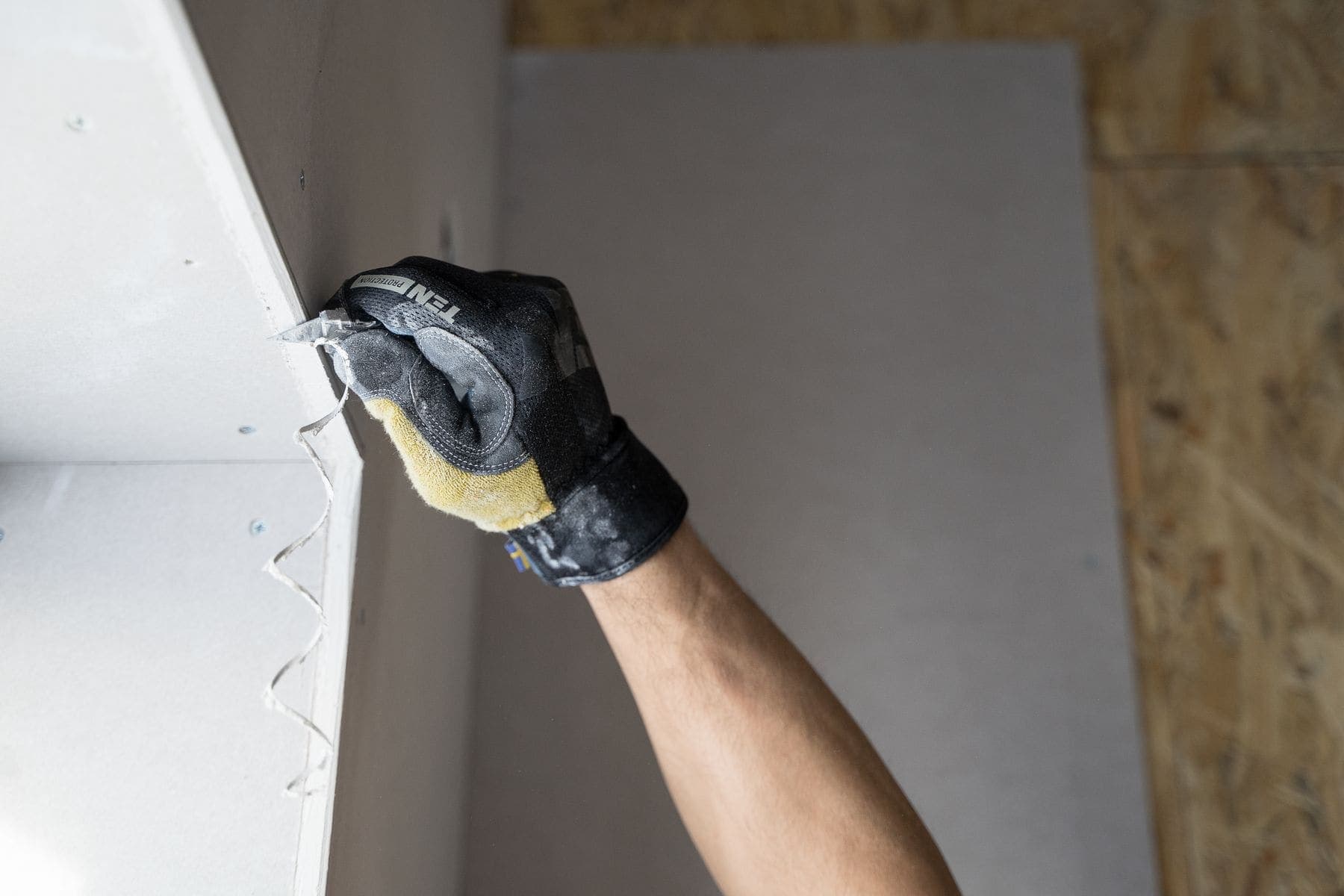 Filling compound being worked into a wall repair before painting