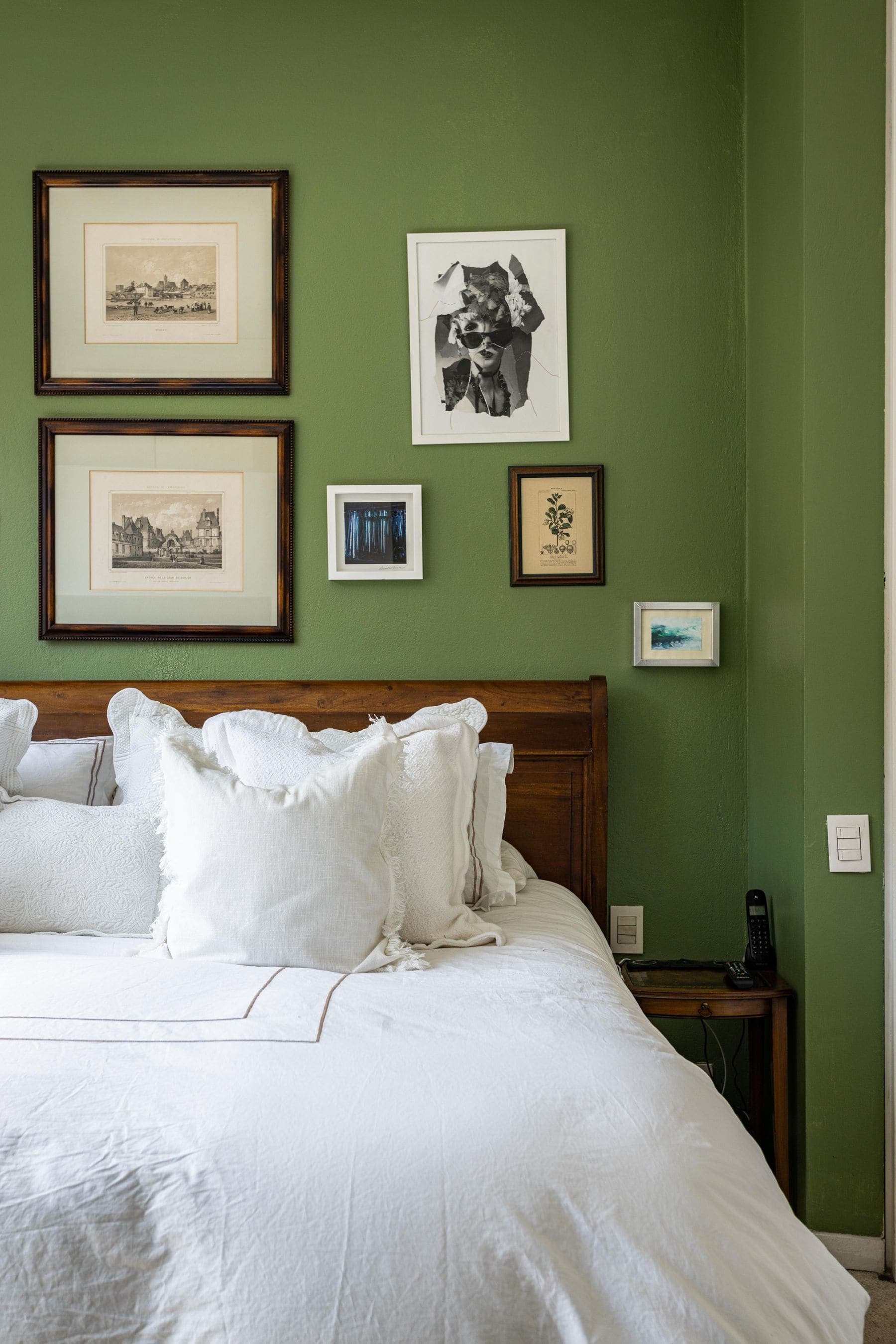 Interior Painting by Brivon — Guest bedroom with a deep green painted wall and crisp white bedding