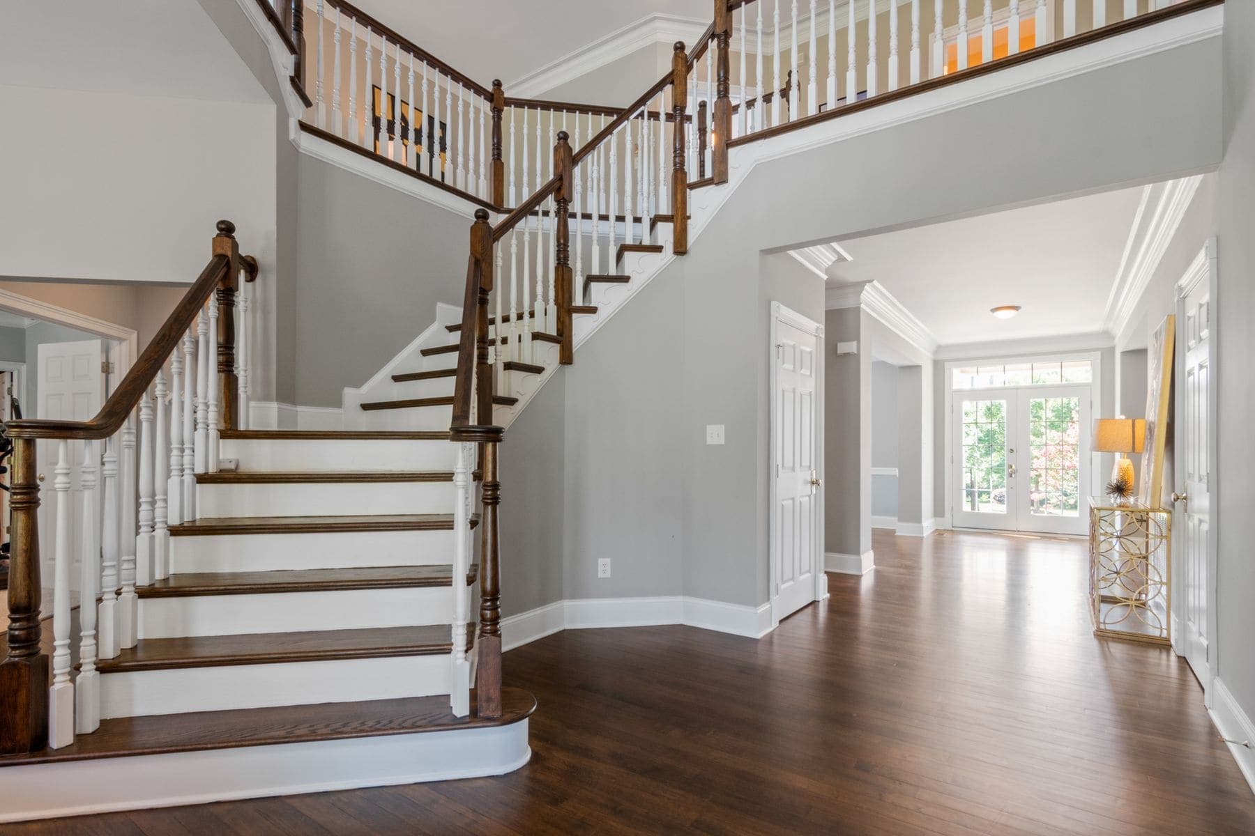 Bright stairwell with cleanly painted walls and white balustrade