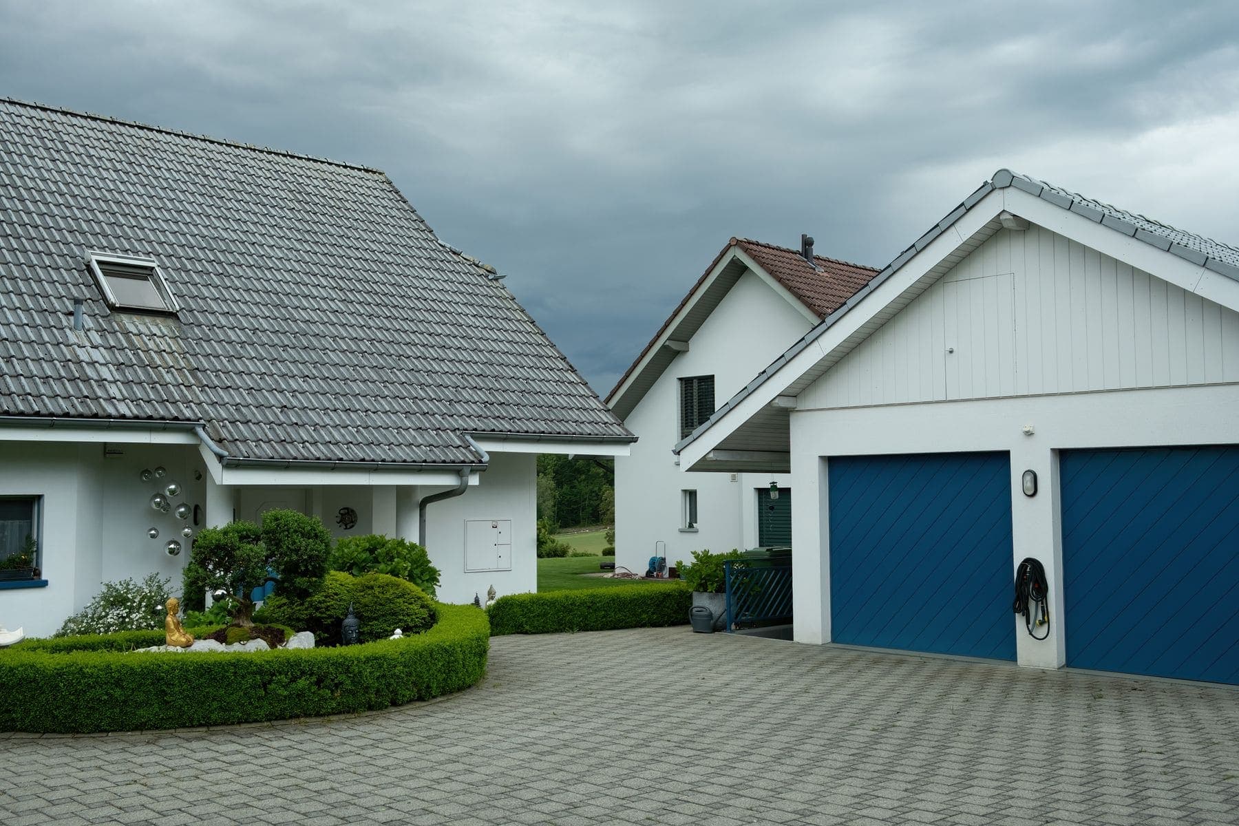 Home exterior with a freshly painted garage door and render