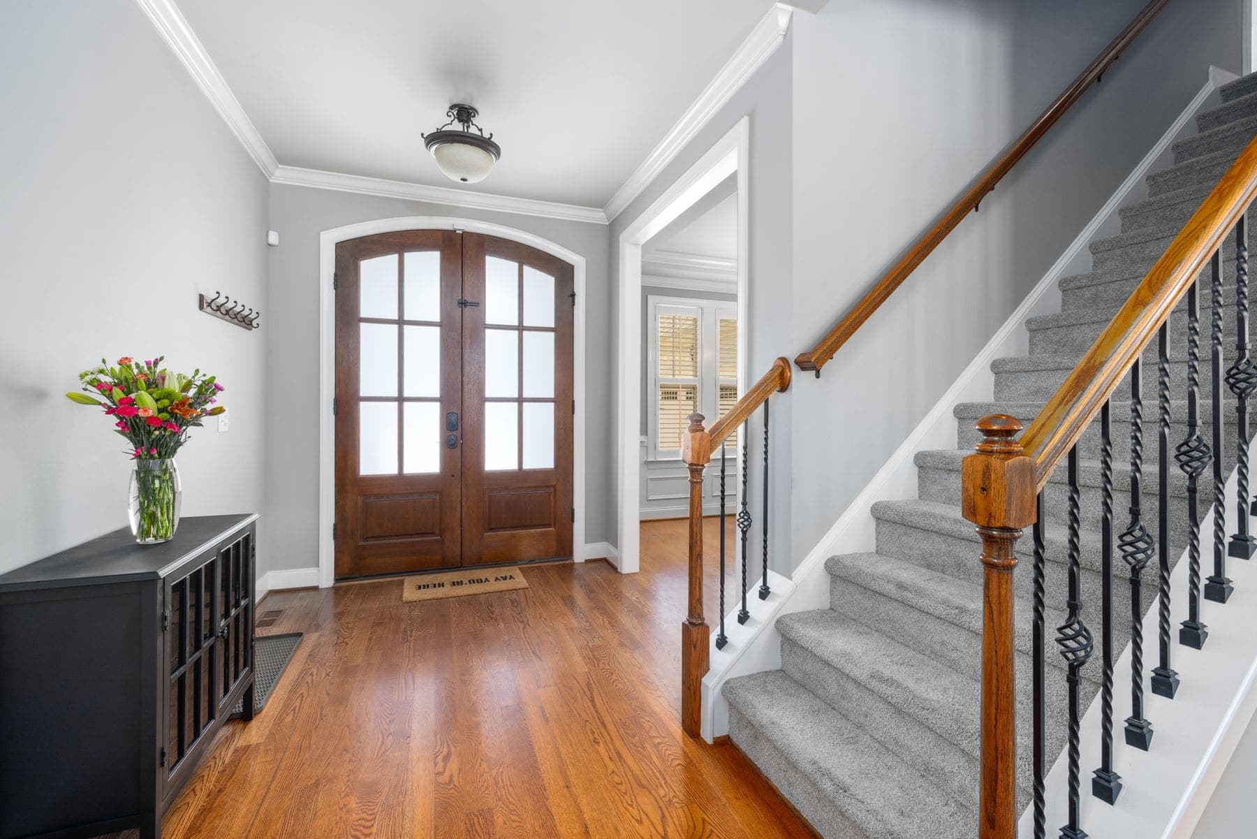 Entry hallway with freshly painted walls, white trim and a timber floor